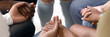 © fizkes - Multi ethnic people sit in circle hold hands during group therapy session close up horizontal photo banner for website header design. Psychological support, people overcome addiction together concept