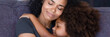 © fizkes - Horizontal photo banner for website header design close up african mom hug little daughter sit on sofa enjoy moment of sweet embracing showing love care, parental protection, motherhood, unity concept