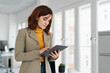 © contrastwerkstatt - Thoughtful young businesswoman using a tablet