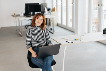 Wall Mural - Sweet sincere businesswoman looking at camera