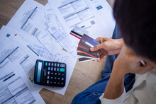 Business People Are Stressed About Credit Card Debt And Many Bills On The Floor. Men Get Trouble By Calculating Monthly Expenses And Then Budgeting Not Enough Money For Paying Debts.