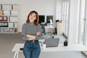 Friendly young businesswoman with thoughtful look