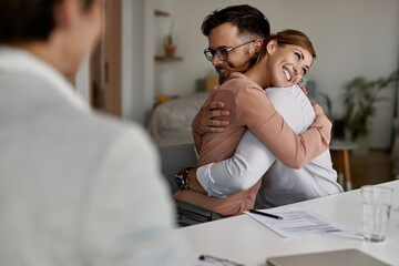 Poster - Happy couple embracing after signing a contract with real estate agent.