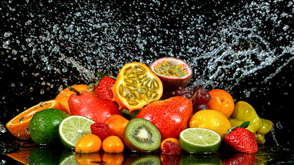 Wall Mural - Freeze Motion Shot of Fresh Fruits with Splashing Water Isolated on Black Background.