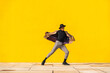 © VISTA by Westend61 - Young man dancing in front of yellow wall