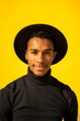 © VISTA by Westend61 - Portrait of young man, wearing black in front of yellow wall
