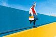 © VISTA by Westend61 - Young man with bag, dancing carefree on a yellow wall