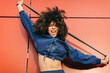 © VISTA by Westend61 - Screaming young woman exercising with resistance band outdoors
