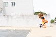 © VISTA by Westend61 - Teenage girl jumping with basketball outdoors
