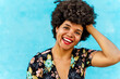 © VISTA by Westend61 - Portrait of smiling female Afro-American woman, hand in hair