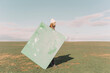 © VISTA by Westend61 - Young woman holding green painting on dry field
