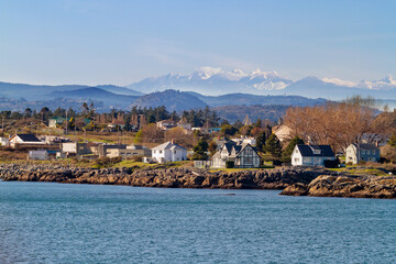 waterfront home with rocky coast , sunny autumn evening with a fall scenery.
