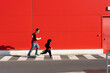 © VISTA by Westend61 - Man running together with his little girl wearing black fancy dress on zebra crossing