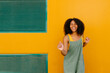 © VISTA by Westend61 - Portrait of happy young woman wearing overalls in front of yellow wall