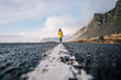 © VISTA by Westend61 - Iceland, woman walking on median strip of country road