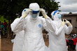 © Belen B Massieu - Lunsar, Sierra Leone, July 8, 2015: Buerial team members ready to take a body in a village. ebola response epidemic disease in Africa, ebola and corona virus context. Editorial use