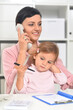 © aletia2011 - Businesswoman with her child working in office