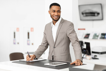 Wall Mural - Auto Dealer Standing At Counter Working In Dealership Office