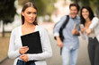 © Prostock-studio - Unhappy Girl Being Bullied By Couple Of Students Walking Outdoor