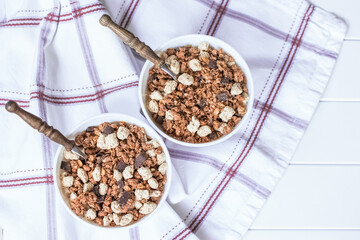 granola with chocolate pieces in bowls on the table top view. granola on the dining table.