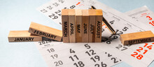 9 Months From January To September On Wooden Blocks On Calendar Sheets. Months Concept