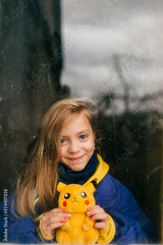 Cuadros en Lienzo MInsk, Belarus - December 8, 2019: Lovely girl in jacket and hoody holds pikachu