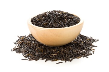 Wall Mural - Heap of uncooked, raw, black wild rice grains in wooden bowl over white