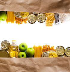 Wall Mural - Food delivery, Donation. Food supplies crisis food stock for quarantine isolation period on white background. Pasta, canned food, apples, oil, crackers.