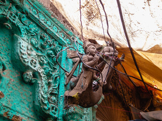 Wall Mural - An exquisitely carved mythological figure on an ancient doorway in Varanasi.