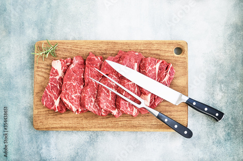 Fresh raw beef steaks on wooden cutting board Canvas Print