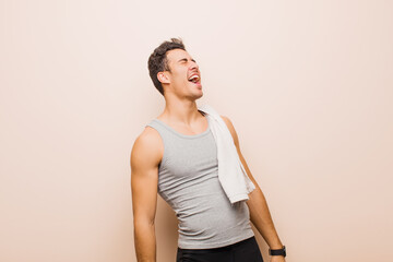 Wall Mural - young arabian man screaming furiously, shouting aggressively, looking stressed and angry. sport concept