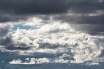 Detail of towering dramatic clouds in the Andean skies, stormy cloud formations laden with water about to precipitate, contrasted by the afternoon lights.