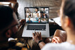 Online business meeting. Business colleagues communicate by a video conference using a laptop, solving and analyzing business affairs. On a laptop screen, participants of a video conference