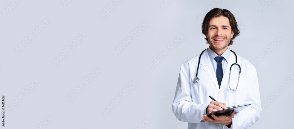 Medical Services. Handsome Doctor With Stethoscope And Clipboard Writing Prescription To Patient - obrazy, fototapety, plakaty 