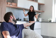 © ASDF - Happy young couple have fun in modern wooden kitchen