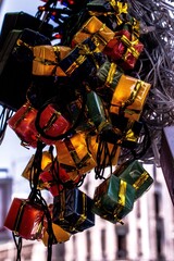 Canvas Print - Vertical closeup of Christmas tree lights shaped like presents