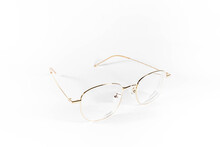 Gold Frame Spectacles Glasses In A White Isolated Background