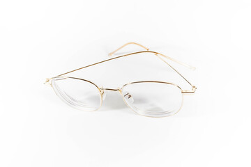 Gold frame spectacles glasses in a white isolated background