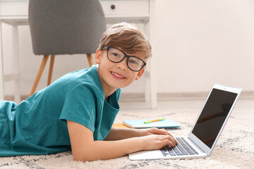 Sticker - Cute little boy studying at home. Concept of online education