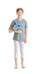 Wall Mural - Cute little boy with yoga mat on white background