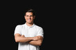 © Pixel-Shot - Sporty young man on dark background