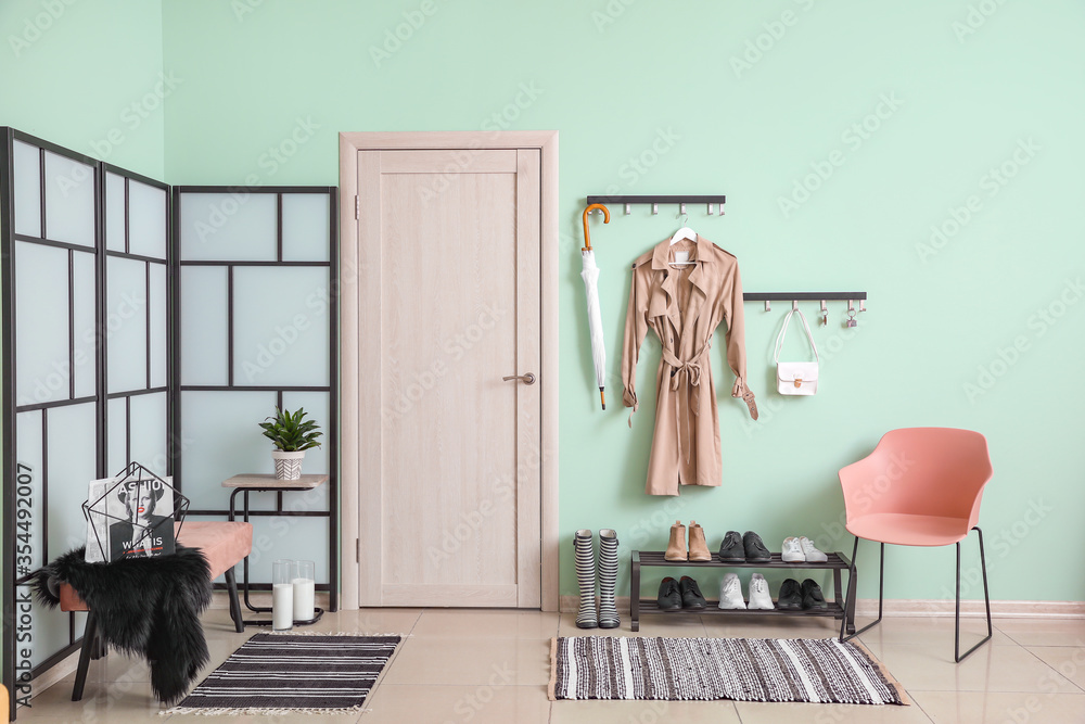 Stylish interior of modern hall with shoes on stand