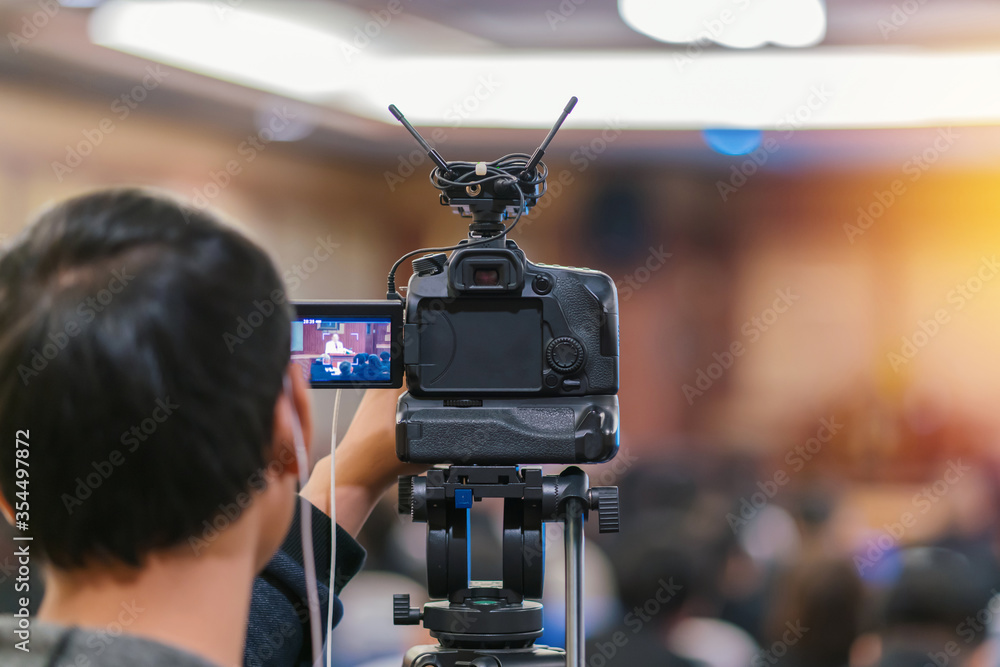 Cameraman taking Vedio to speaker on the stage present in conference hall or seminar meeting, event and seminar concept - obrazy, fototapety, plakaty 