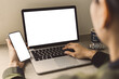 © panitan - computer,cell phone mockup image.hand woman work using laptop texting mobile.blank screen with white background for advertising,contact business search information on desk in cafe.marketing,design