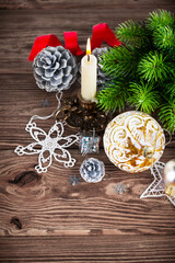 Wall Mural - Branch of Christmas tree with candle and balls. Stock photo.