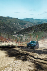 Wall Mural - car travel concept suv driving by country road leading to the mountains