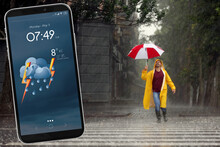 Happy Young Man With Colorful Umbrella Outdoors And Smartphone With Open Weather Forecast App