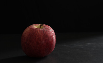 Apples with light in a black background