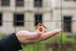 © strigana - Buying a house, building repair and mortgage concept. Estimation real estate property with loan money and banking. Man holding a house in hands