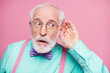Closeup photo of attractive grandpa hand near ear listen rumors focused chatterbox bad person wear specs mint shirt suspenders violet bow tie isolated pink pastel color background